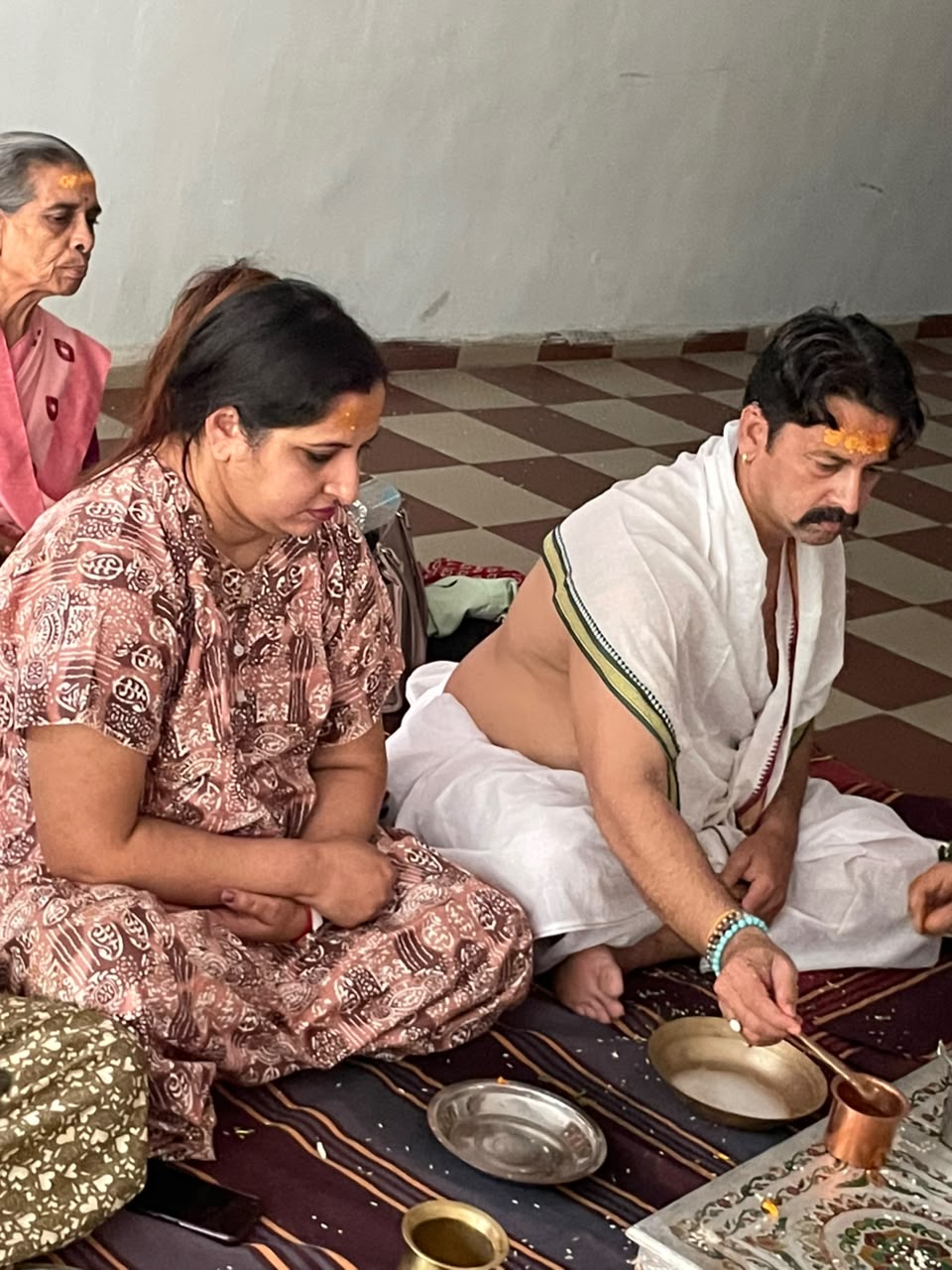 Devotees performing a puja vidhi with Guruji